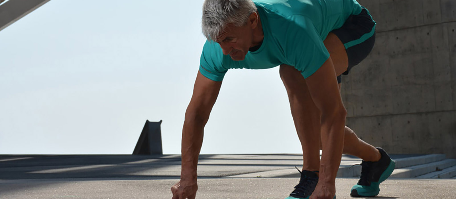 Elderly man practicing sports on the street